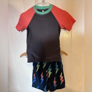 Tea Collection Kids Black Rashguard with Red Sleeves and Lightning-Print Shorts